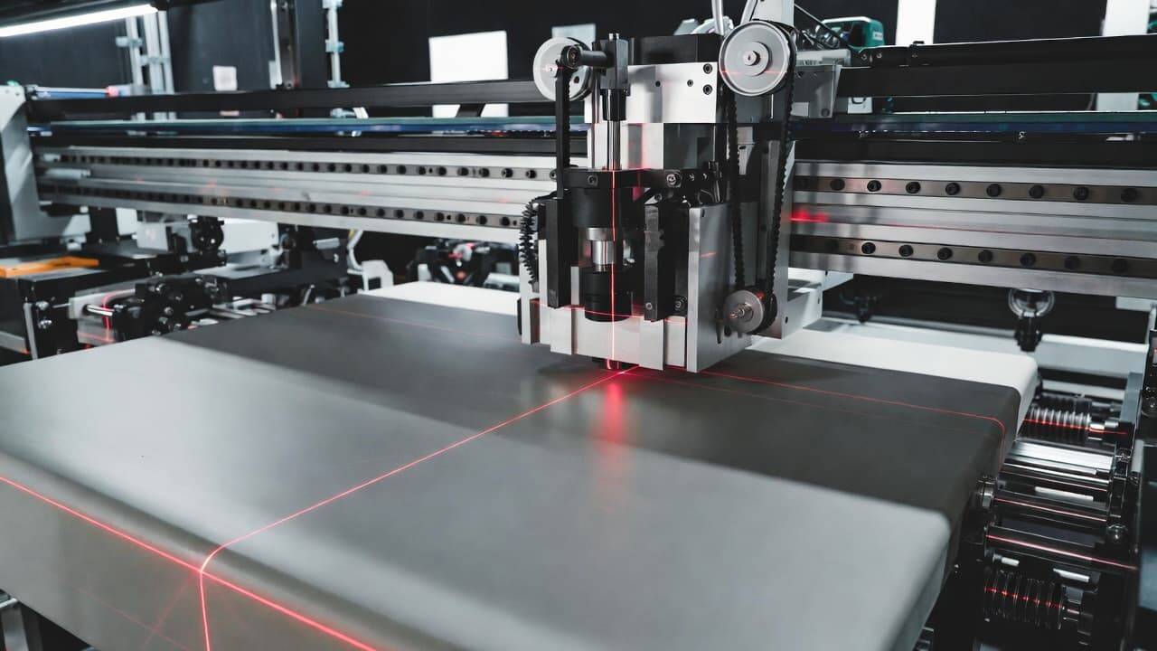 Laser positioning system aligning material in a UV printer