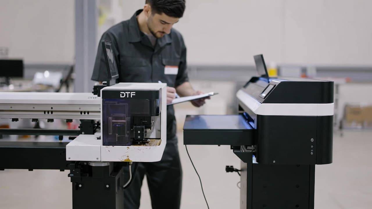 Old DTF printer being evaluated for trade-in next to a brand new upgraded DTF printer