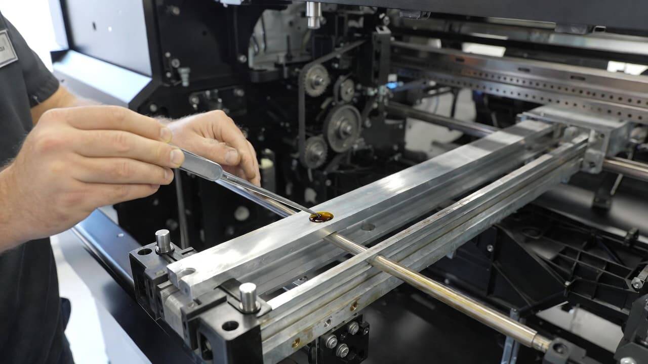 Lubricating DTF printer carriage rail for smooth operation