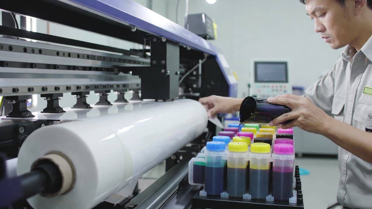 DTF printer loading PET film and ink during setup process